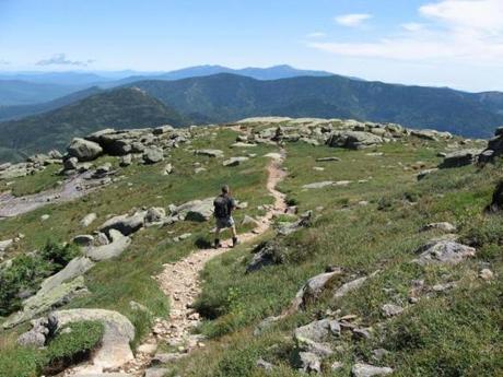 A hiker explores Mount Lafayette, the highest point on Franconia Ridge.
